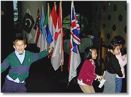 Photo of students marching with flags of the world and their Companion flags
